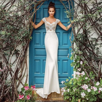 Eleganckie przezroczyste suknie ślubne syreny z okrągłym dekoltem 2021 Cap Sleeve koronki aplikacja Sweep Pociąg suknie ślubne na zamówienie